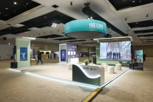 A large-scale LED screen wall and circular overhead branded screen displaying the HSE Expo identity at the SNOC exhibition stand, Al Jawaher, Sharjah — installed by Topaz Events to maximise visual impact and brand visibility across the exhibition hall during HSE Expo 2026.
